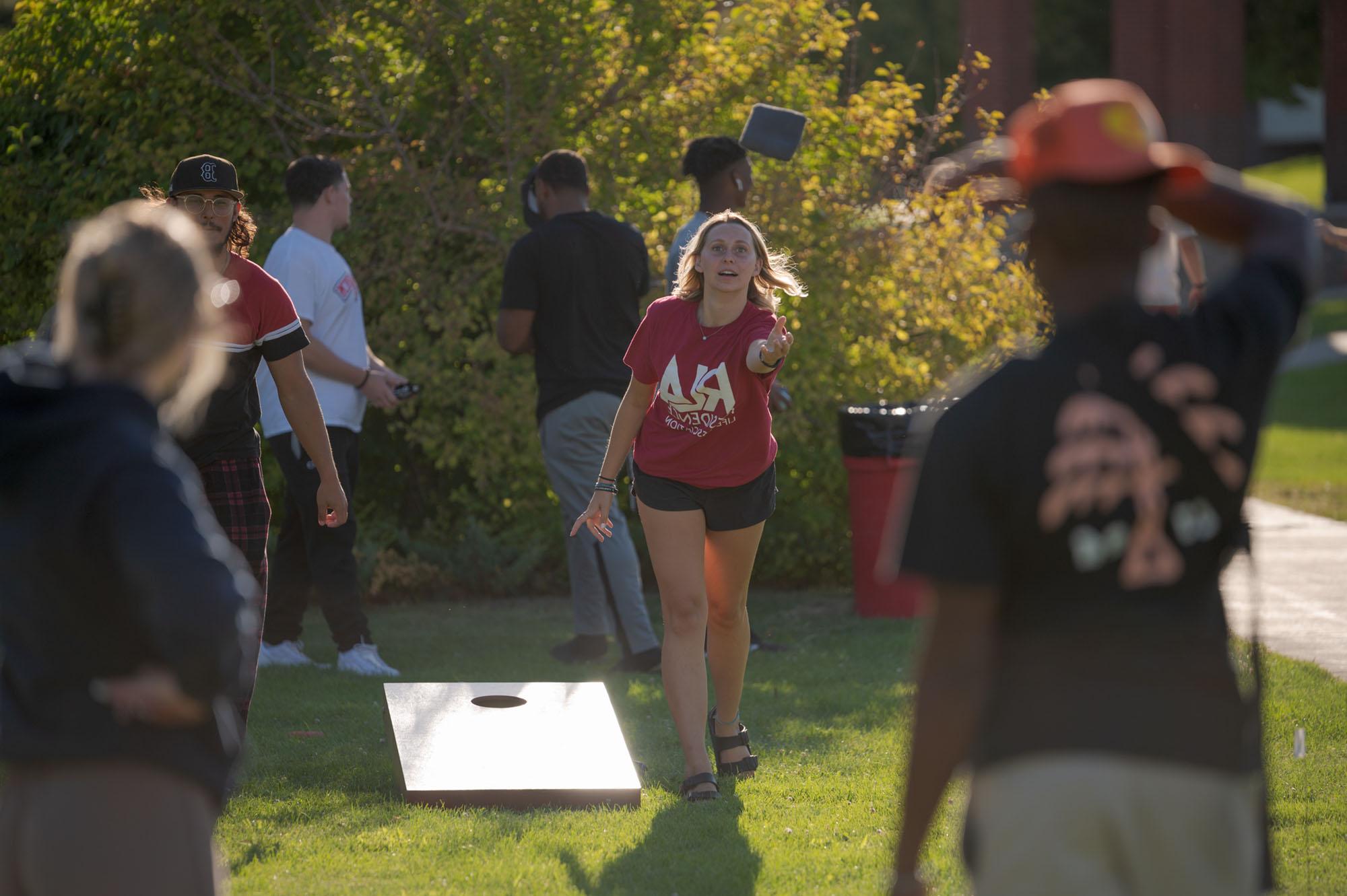 Students playing a bean bag toss